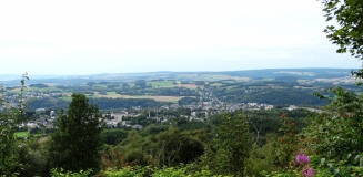 Das Foto zeigt den weiten Blick vom Pöhlberg auf das Annaberger Land mit seiner reich strukturierten Landschaft aus Wäldern, Hecken, Grünland und Äckern und die Stadt Annaberg-Buchholz mit dem markanten Turm der St. Annenkirche.